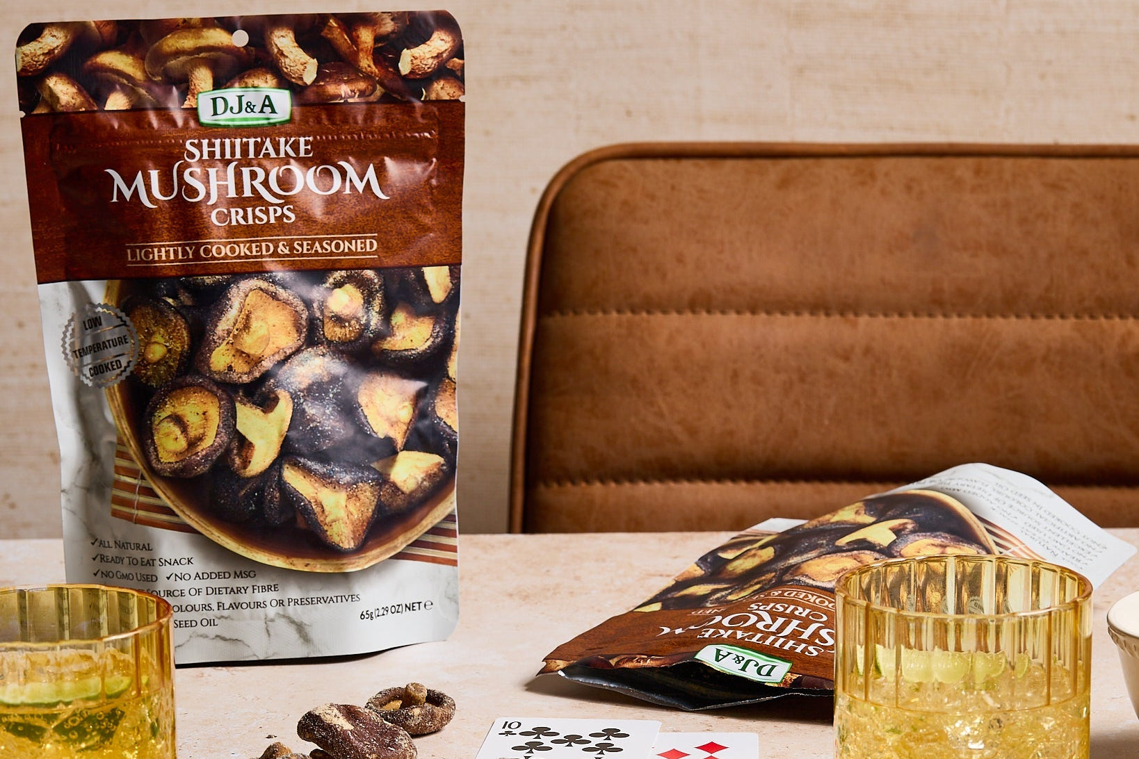 Shiitake mushroom snacks on a table with playing cards and glasses.