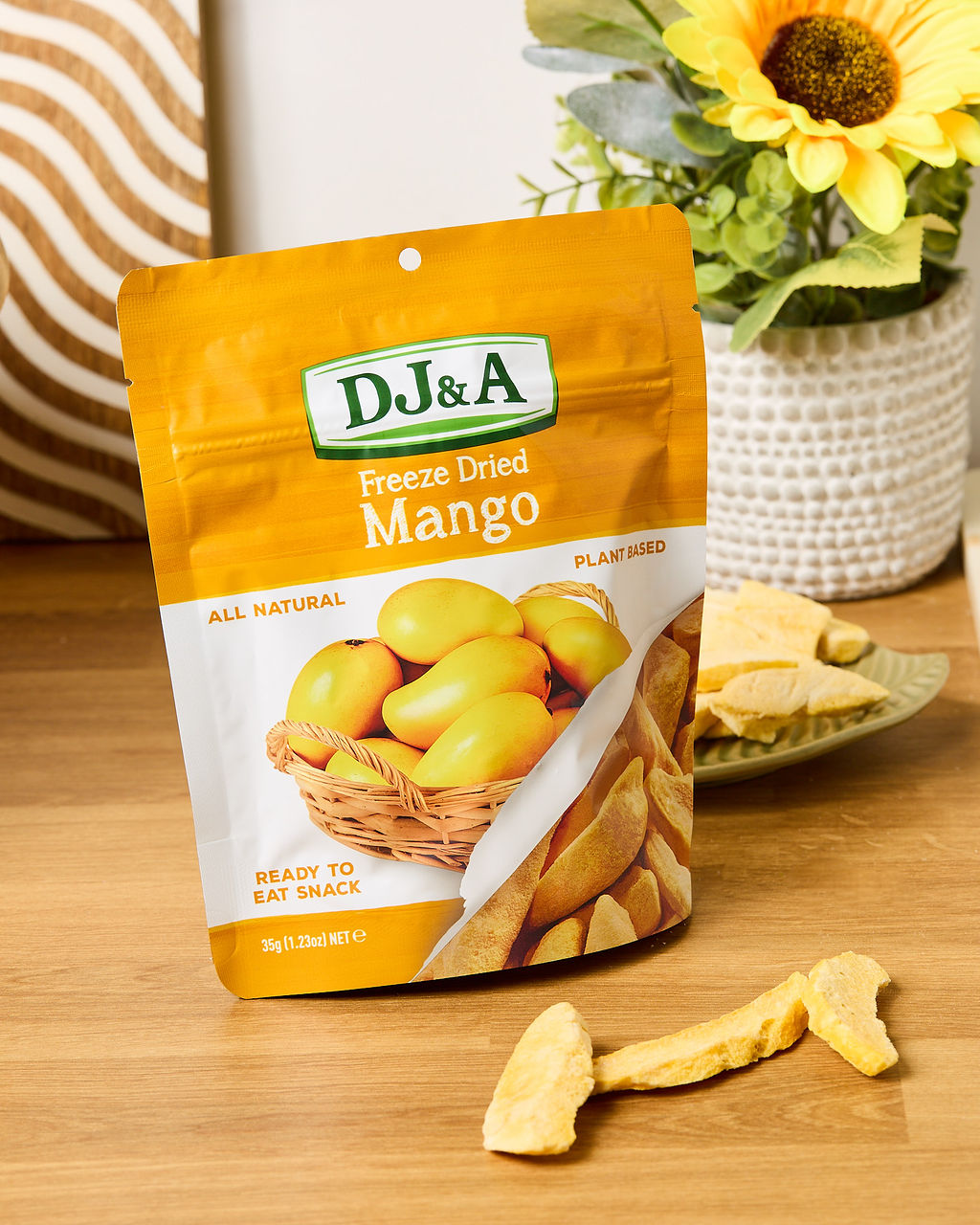 Close-up of DJ & A Freeze Dried Mango pieces, showing their crisp, airy texture.